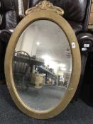 An early 20th century painted oval framed mirror