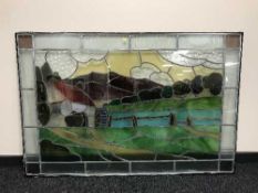 A large stained glass window depicting a water mill