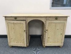 An antique pine knee hole desk