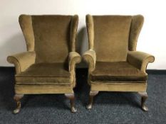 A pair of early 20th century wing back armchairs