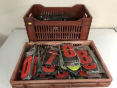 A crate of pet collars, stickers, car battery,