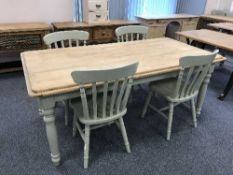 A pine farmhouse kitchen table and four painted chairs