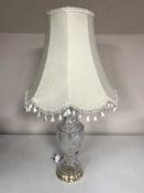 A lead crystal table lamp with shade