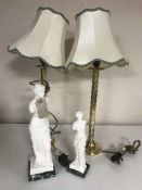 A pair of classical style figures and a pair of table lamps