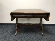 A mahogany drop end library table