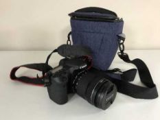 A Canon EOS 70D camera and lens in carry bag