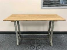 A kitchen centre table on cast iron legs