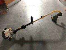 A Ryobi PLT2543Y 25 cc petrol strimmer