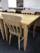 A pine square kitchen table and two chairs