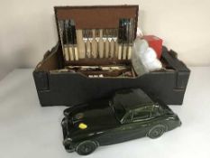 A box of oak canteen of cutlery, Dartmouth pottery china car, place mats, napkin rings,