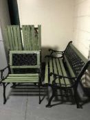 A wrought iron and wooden three piece patio set