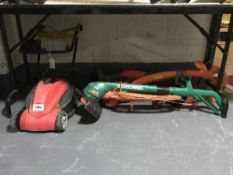 An electric lawn mower and four assorted electric strimmers