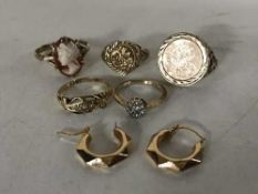 Four 9ct gold rings, an 18ct gold ring and a pair of 9ct gold earrings.