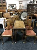 A walnut drop leaf table and four chairs