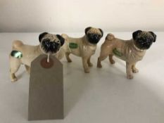 Three small Beswick figures - pugs