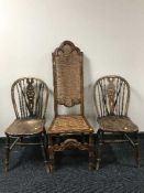 A pair of oak wheel back chairs and a hall chair