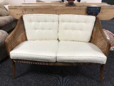 A contemporary two seater bergere back settee