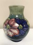 A Moorcroft Clematis vase with blue\green background, height 19cms.