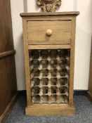 A reclaimed pine bottle rack fitted with a drawer