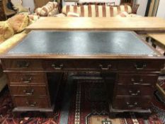 A Georgian style mahogany pedestal desk with green tooled leather top,