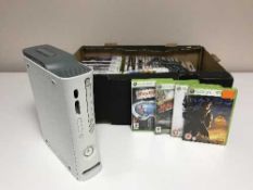 A box of Xbox 360 with leads and games