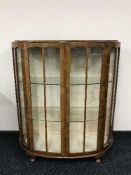 A walnut d-shaped display cabinet