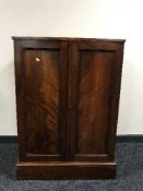 A mahogany double door cabinet and a fire screen