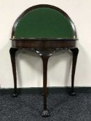 A foldover card table on claw and ball feet