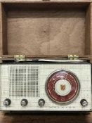 A deed box containing an old radio