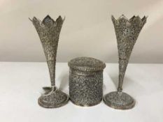 A pair of continental silver embossed vases together with a similar lidded tobacco jar
