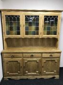 A blonde oak leaded door kitchen dresser