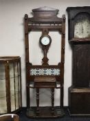 A late Victorian oak hall stand fitted a barometer