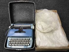 A Smith Corona sterling typewriter and a vintage wedding dress in box