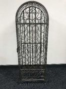 A metal cage bottle rack