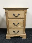 A pine three drawer chest