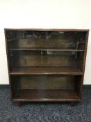 A mahogany sliding door bookcase