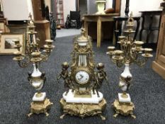 An ornate gilt three-piece clock garniture.