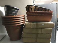 A quantity of plastic garden planters, hanging baskets and troughs,
