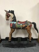 A painted wooden rocking horse
