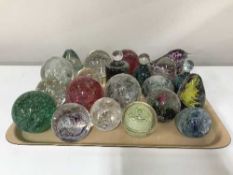 A tray of twenty one assorted glass paperweights
