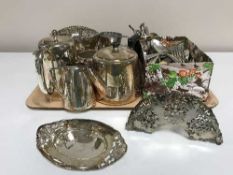 A tray of plated pieces and a box of assorted cutlery