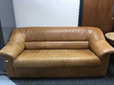 A brown leather three seater settee