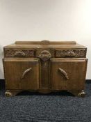 An early 20th century carved oak sideboard