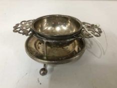 A silver strainer on stand