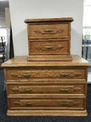 An oak three drawer chest and pair of bedside chests