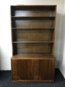 A set of mahogany open shelves fitted a cupboard