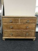 An antique pine drawer chest with glass handles