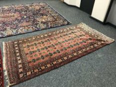 A fringed Afghan rug on red ground 260 cm x 128 cm