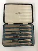 A set of six cased silver handled butter knives
