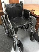 A folding chrome wheel chair